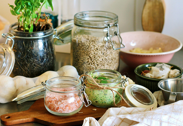 A group of grains, seeds, salt, and other things in a jar.